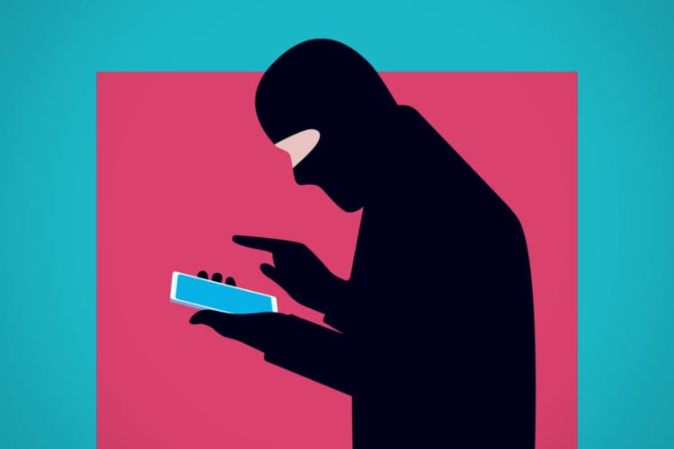 Illustration of a masked fraud actor using his smartphone.