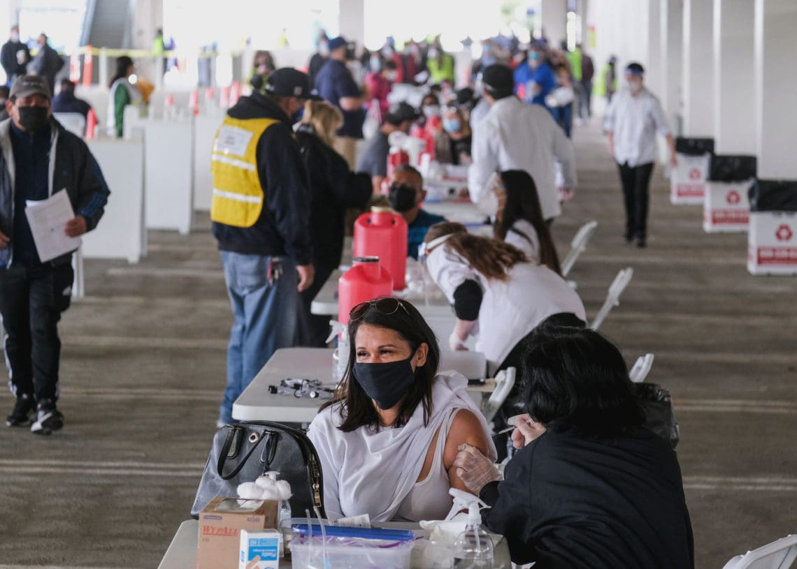 People receive the covid vaccine in a California vaccination center.