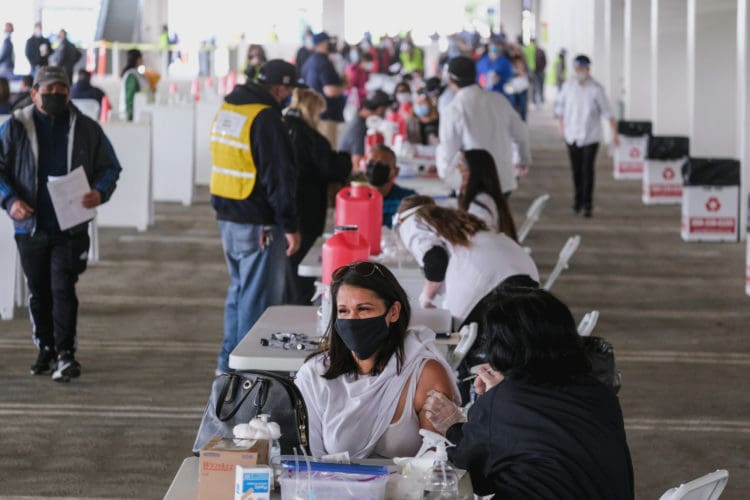People receive the covid vaccine in a California vaccination center.