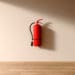 A fire extinguisher hangs on a white wall