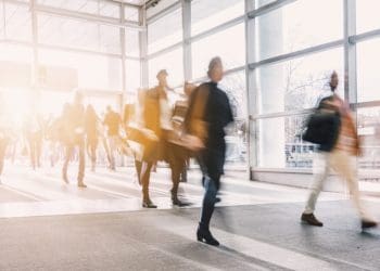 businesspeople walking in busy lobby