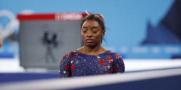Simone Biles prepares to compete at Tokyo Olympics.
