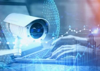 CCTV camera superimposed over hands typing