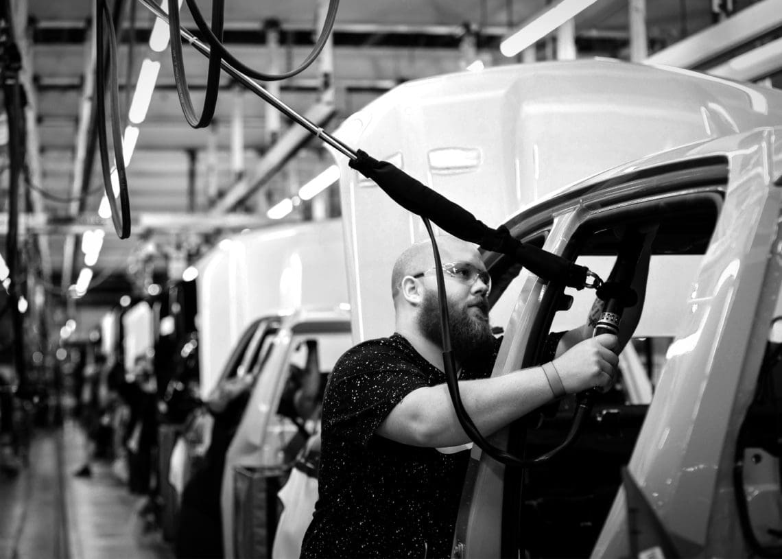 A man works at a GM factory.