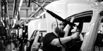 A man works at a GM factory.