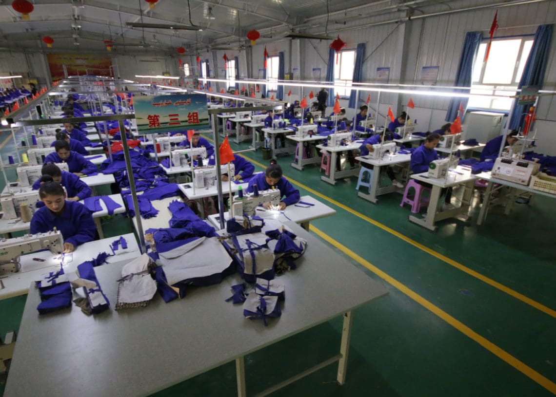 Uyghur women work at a textile factory in Xinjiang