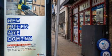 A billboard annoucning new rules for businesses post brexit in london.