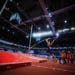 A pole vaulter takes off trying to clear a high bar