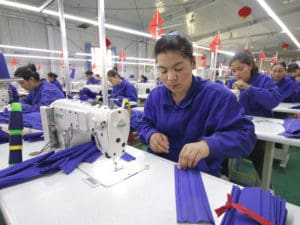 Uyghur women work at a textile factory in Xinjiang
