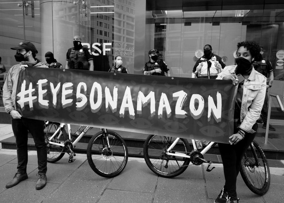 Demonstrators protest outside amazon investment firm