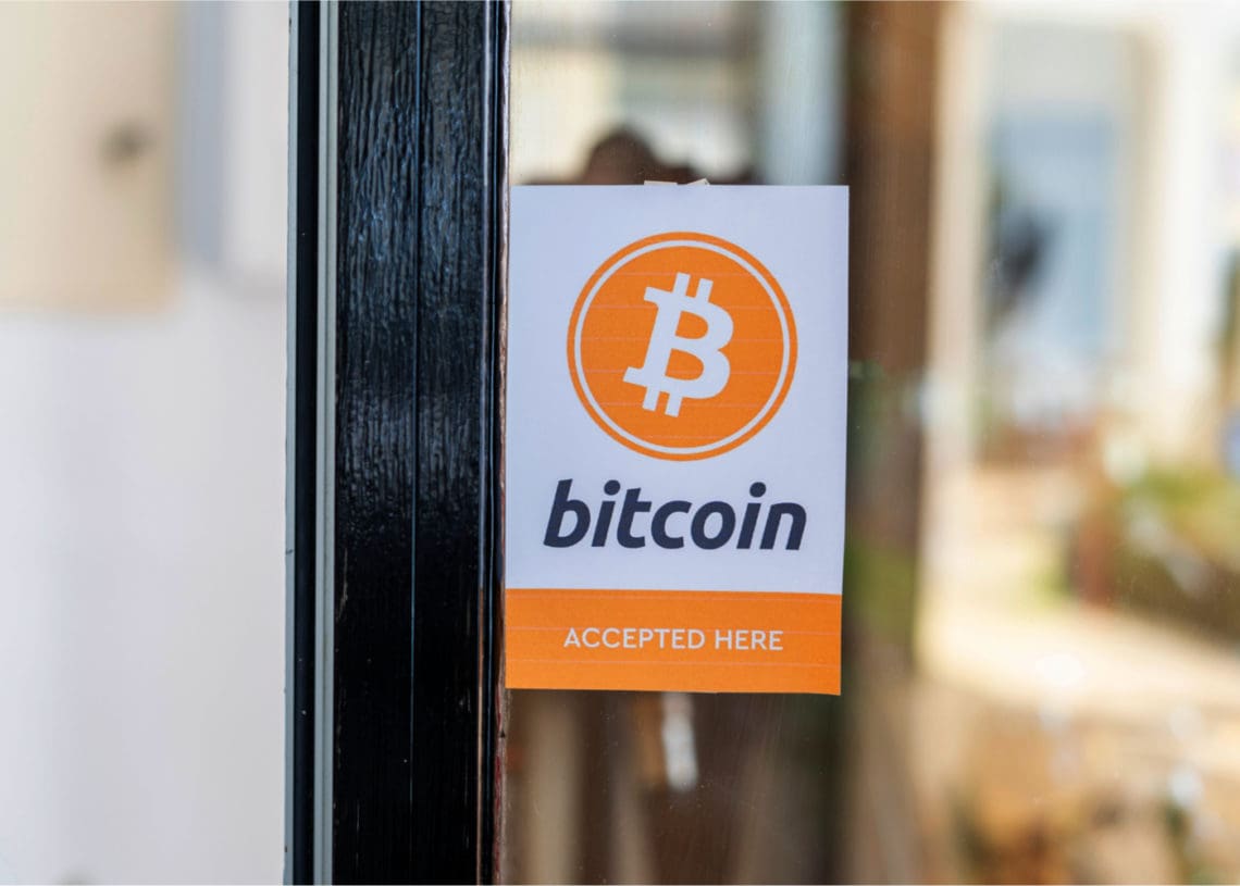 Store bears a sign on its door saying it accepts bitcoin