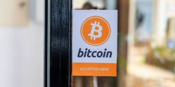 Store bears a sign on its door saying it accepts bitcoin