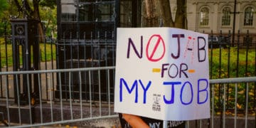 An unidentified New Yorker protests vaccine mandates at work.
