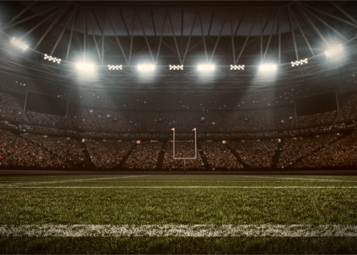 Football stadium with goal posts visible in the distance.