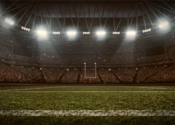 Football stadium with goal posts visible in the distance.