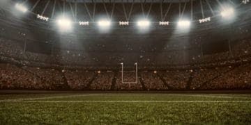 Football stadium with goal posts visible in the distance.