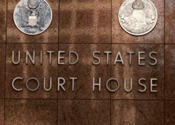 Building facade reads United States Court House - District Court in Texas .