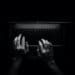 overhead b and w shot of a person's hands typing on a laptop.