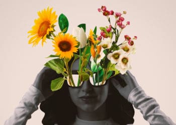 a young woman has flowers growing out of her glasses