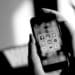 b and w a person uses a smart phone with social media