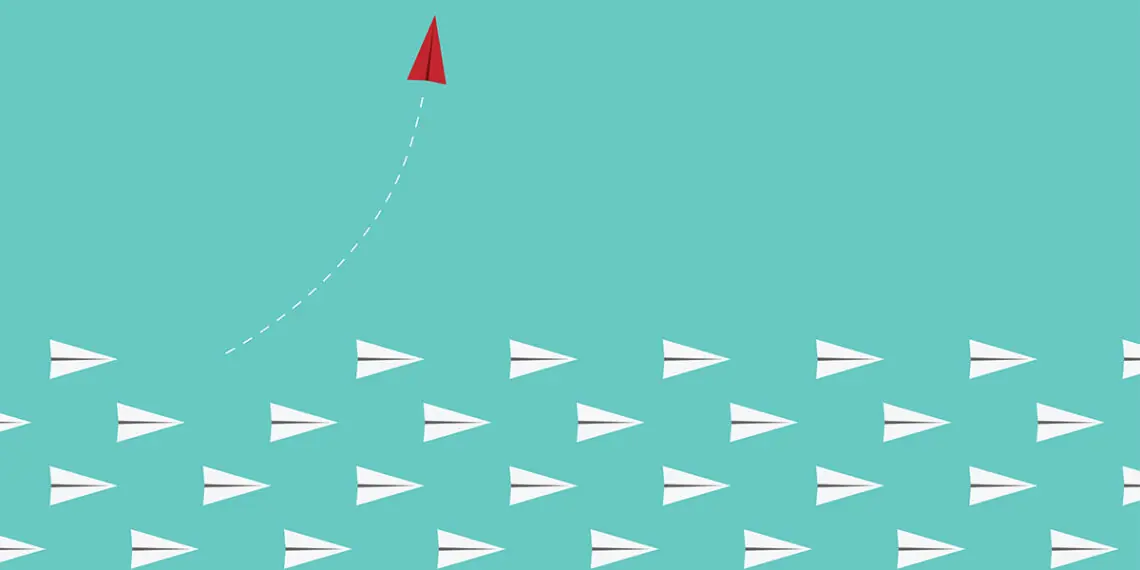 red paper airplane leaves other paper airplanes