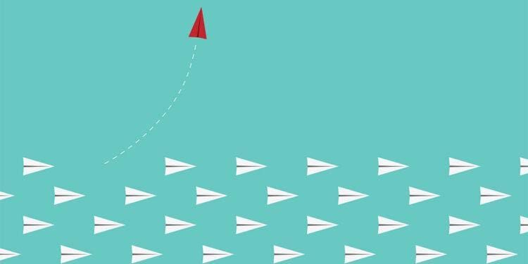 red paper airplane leaves other paper airplanes