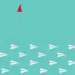 red paper airplane leaves other paper airplanes