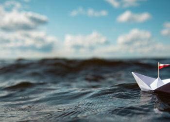 paper boat in ocean