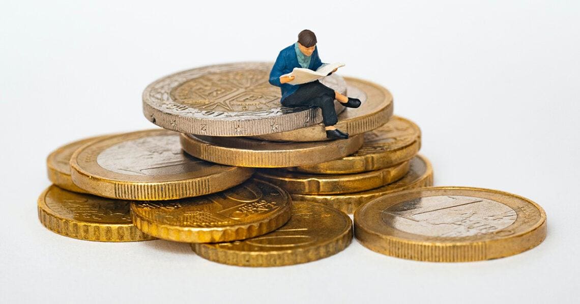 little man on stack of coins