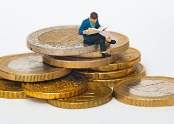 little man on stack of coins