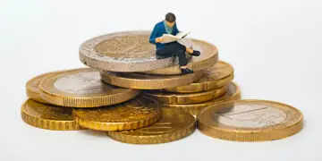 little man on stack of coins