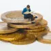 little man on stack of coins