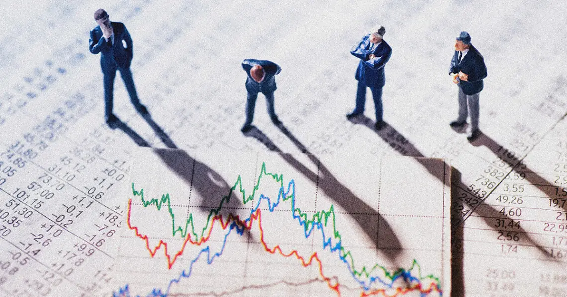 Businessman figurines looking at graph