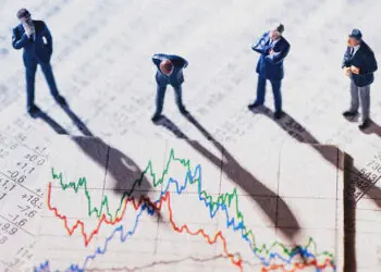 Businessman figurines looking at graph