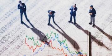 Businessman figurines looking at graph