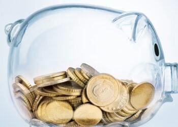 a clear piggybank holding coins