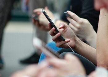 people on train looking at phones