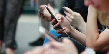 people on train looking at phones