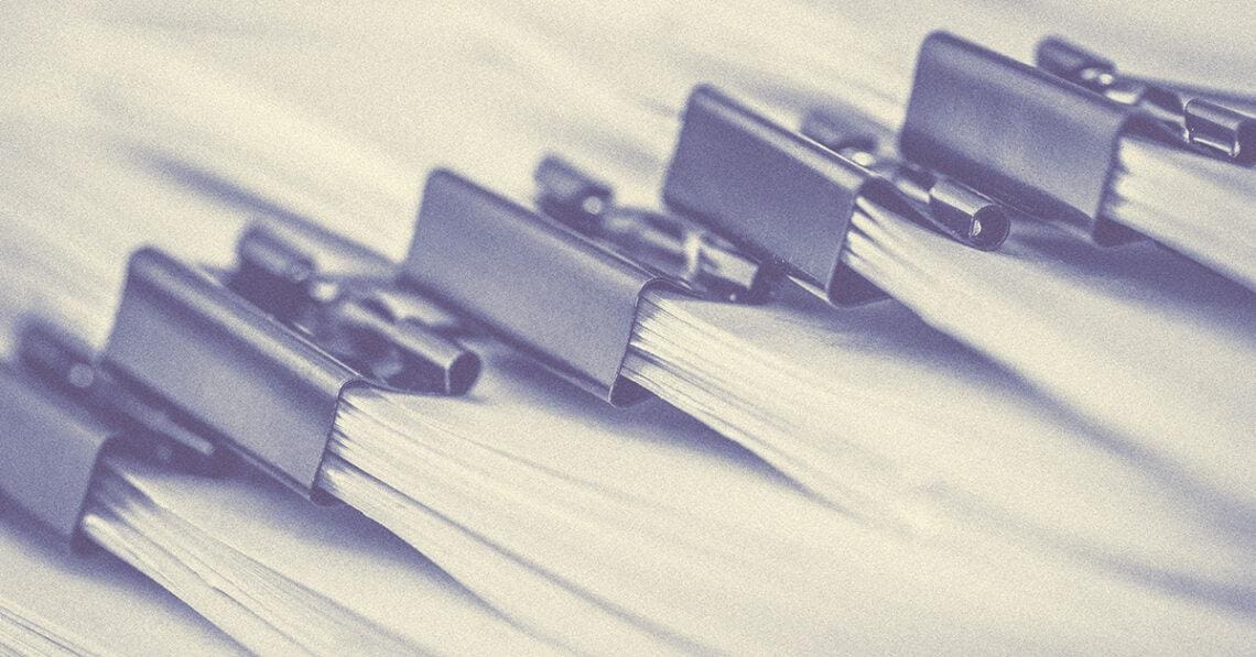 bundle of papers with binder clips