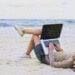 freelance worker sitting on beach