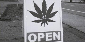 sign in front of weed dispensary