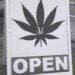 sign in front of weed dispensary