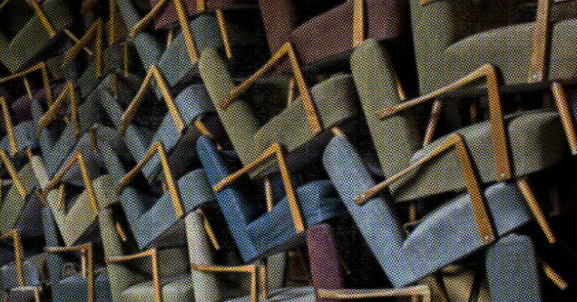 a bunch of chairs piled up