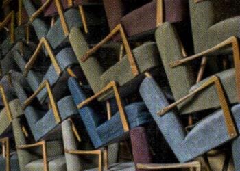 a bunch of chairs piled up