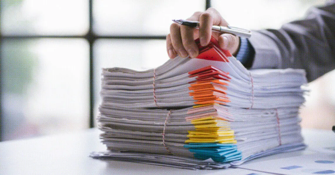 analyst going through stack of papers