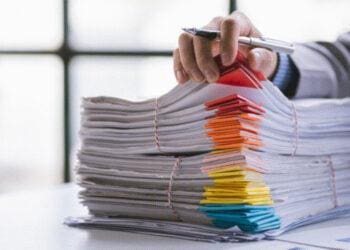 analyst going through stack of papers