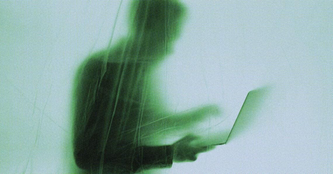 hacker behind a curtain