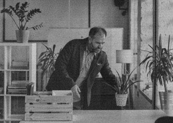 man bringing plants to his office