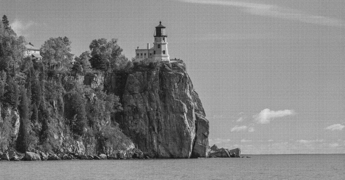 a lighthouse at the edge of a cliff