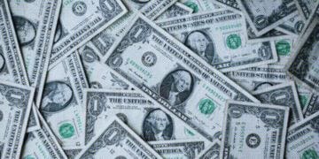 dollar bills piled up